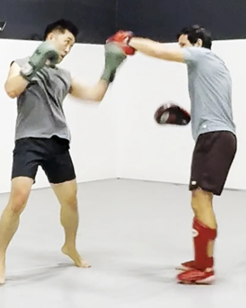 Punch landing on the pads during Muay Thai mitt work